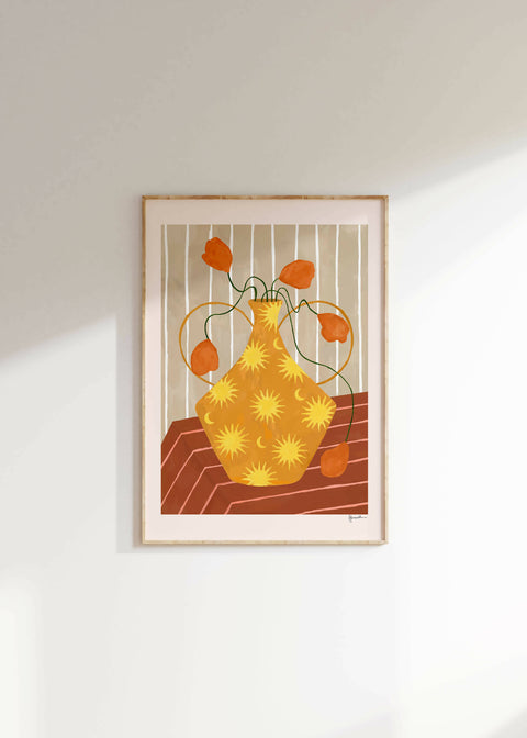 orange flowers in sun and moon vase