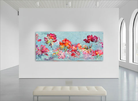 red and orange roses against a light blue background in an impressionistic style - floral wall art by wendy farrow shown in a gallery setting
