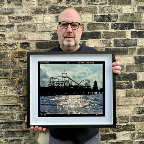 Richard holding Pleasure Pier Landscape 445 Black Frame