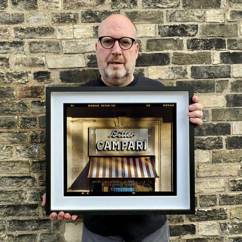 Richard holding Bitter Campari Sign Landscape 445 Black Frame